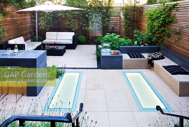 Modern garden with built in benches and dining area 
