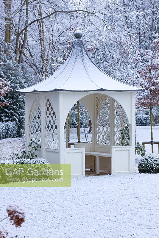 Formal town garden with gazebo covered in snow, Oxford, UK. 