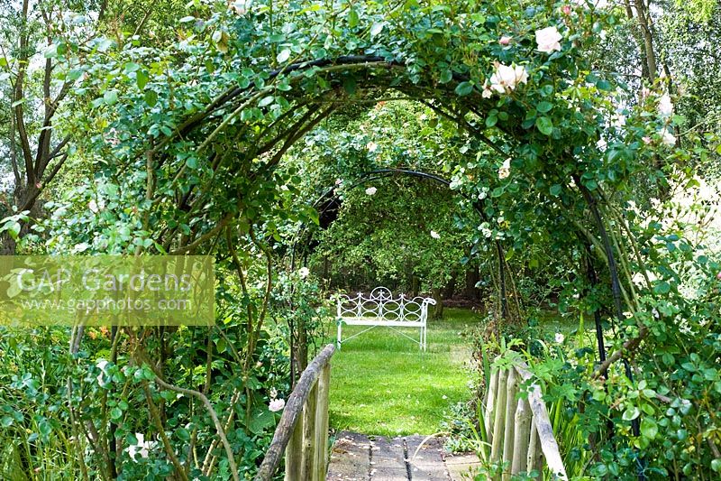 Rose covered bridge with seat
