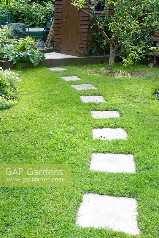 Paving slabs embedded in lawn to create path