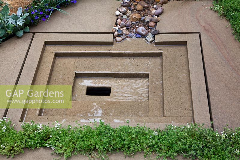 Decorative, York stone water drainage sump in 'The Art of Yorkshire garden', sponsored by Welcome to Yorkshire - RHS Chelsea Flower Show 2011