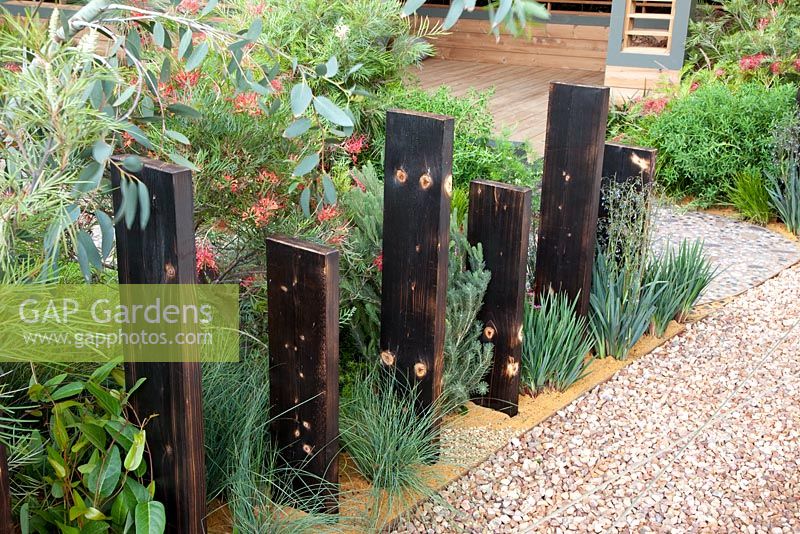 Timber used as an informal fence with mediterranean style planting - 'A Monaco Garden' - Gold Medal Winner, RHS Chelsea Flower Show 2011 