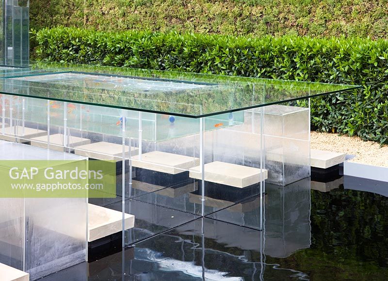 Glass table and seating area with pool below - 'The B and Q Garden', Gold Medal Winner, RHS Chelsea Flower Show 2011 