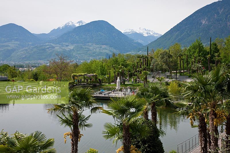 Snow covered mountain tops in the background of the botanical gardens of Trauttmansdorff Castle, Merano, Italy
