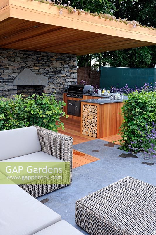 Modern contemporary garden with outdoor cooking area and fireplace. 'Inside Out' garden. RHS Tatton Park Flower Show 2011
