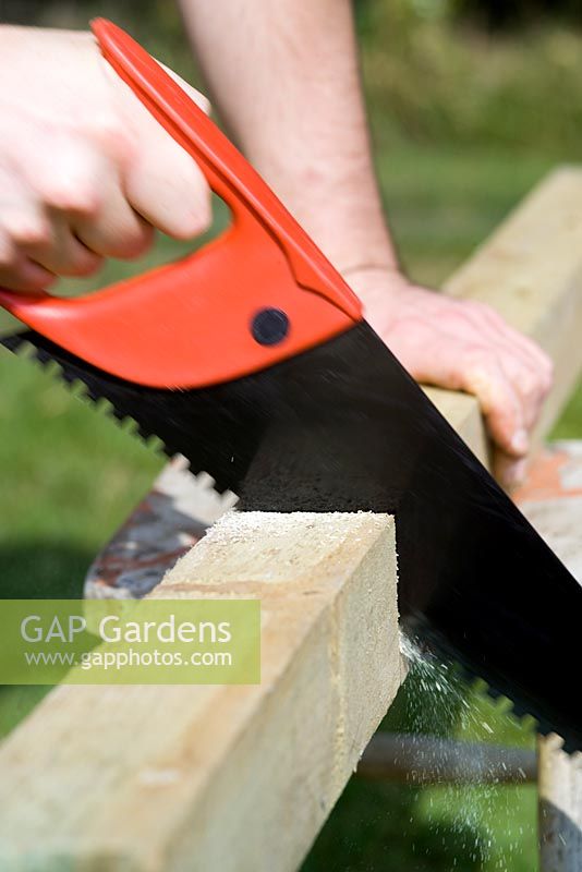 step by step, making a raised bed - cutting wood uprights