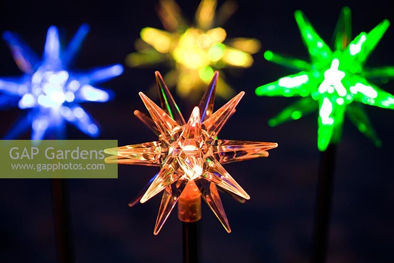 Coloured star solar powered Christmas lights at night