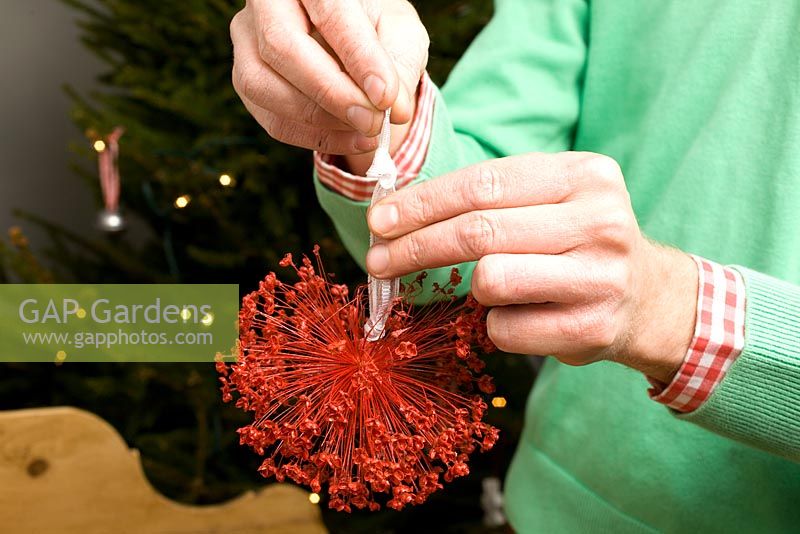 Making homemade Christmas tree decorations with sprayed seedheads