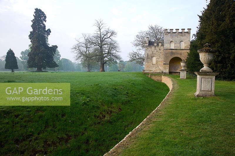 Urn beside the ha-ha, separating the garden from the surrounding parkland, with Gothic Seat, designed by William Kent - Rousham House, Bicester, Oxon, UK