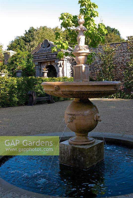 Upper terraces in the Collector Earl's Garden feature fountains with dogs' head spouts, and a temple decorated with deer antlers made from oak, designed by Julian and Isabel Bannerman.