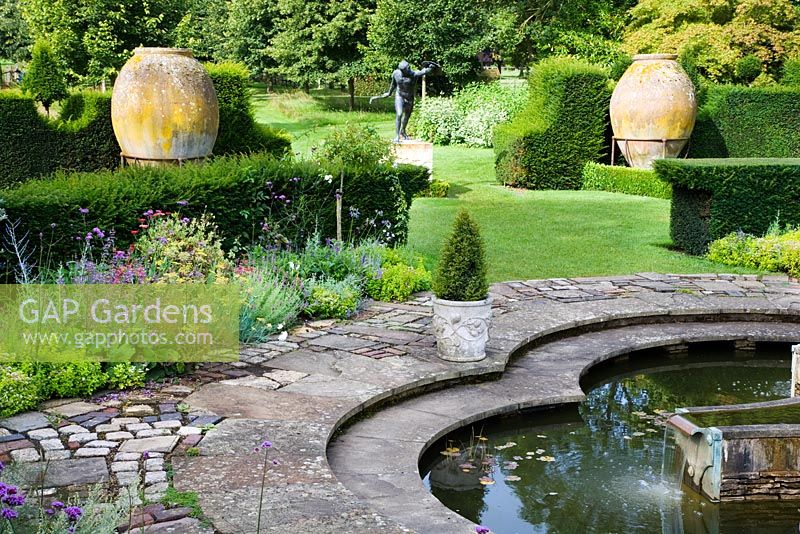 The Mediterranean Garden with the Lilly Pool, two large Spanish sherry jars and bronze statue the Borghese Gladiator, Highgrove Garden, August, 2007. 