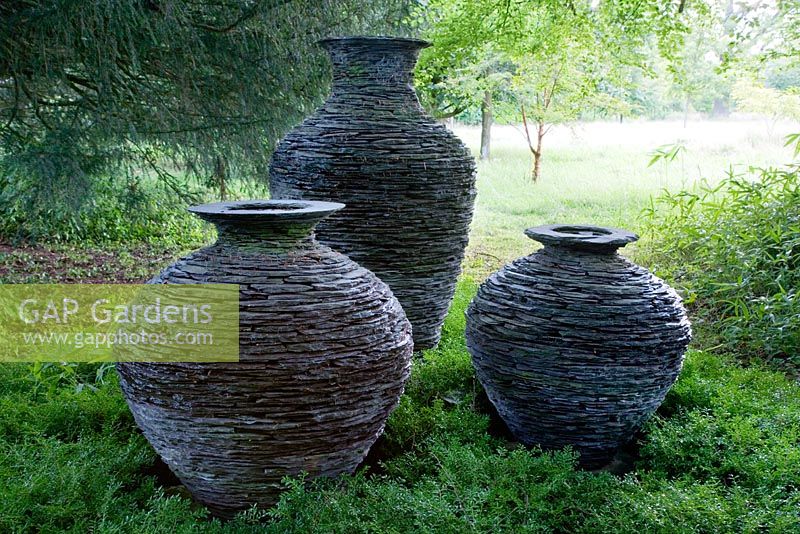 Large slate pots on the edge of the Wild Flower Meadow. These were made using a technique akin to dry stone walling. 