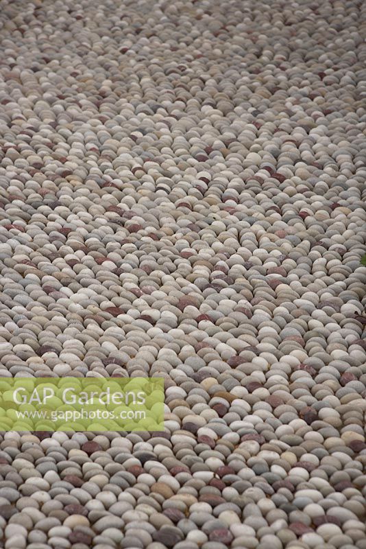 Pebbles inlaid in paved area