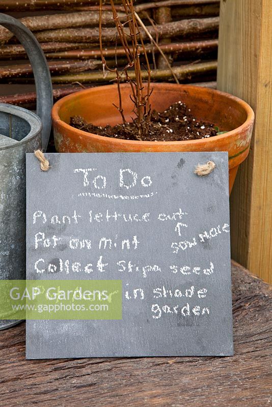 Small blackboard with gardeners to do list 
