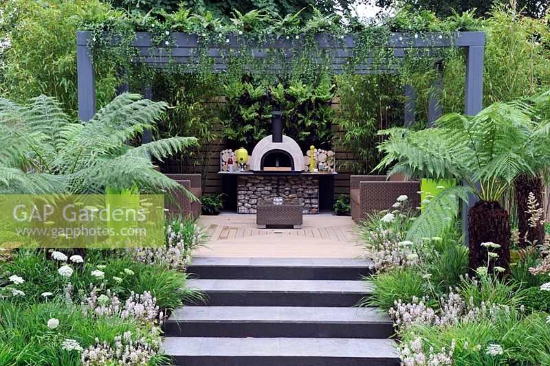 Seating and cooking area with living pergola planted with ferns, Tellima Grandiflora and Dicksonia along garden steps - Live Outdoors, Hampton Court palace flower show 2012