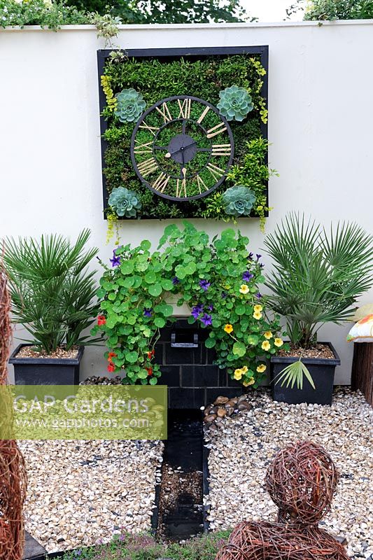 Floral, living clock on garden wall, 'The Wheels of Time Garden', Hampton Court Palace Flower show 2012