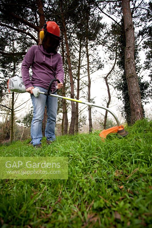 Woman using a strimmer
