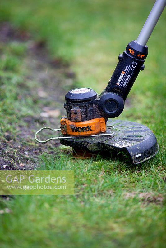 Strimmer edging a lawn