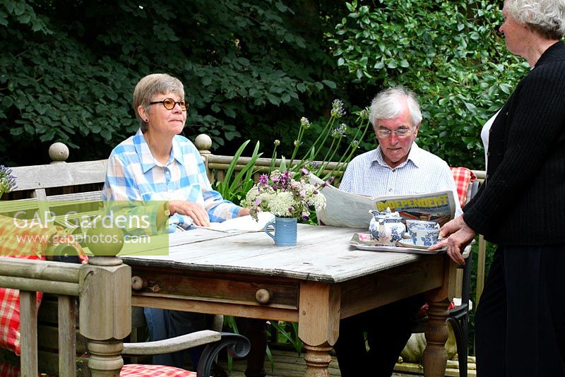 Caroline Musker serving tea to B&B guests on the verandah - Sallowfield Cottage, Norfolk