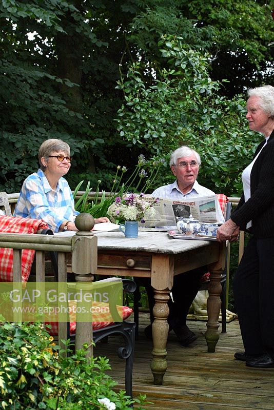 Caroline Musker serving tea to B&B guests on the verandah - Sallowfield Cottage, Norfolk