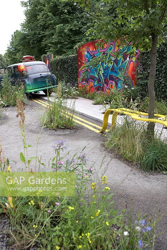 The Edible Bus Stop. Hampton Court Flower Show 2012. A London taxi cab and a phone box along with the road itself, have been vandalised but reclaimed by nature.