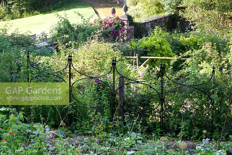 Walled kitchen garden in summer, agriframes screens in the garden - Cerney Gardens, Gloucestershire