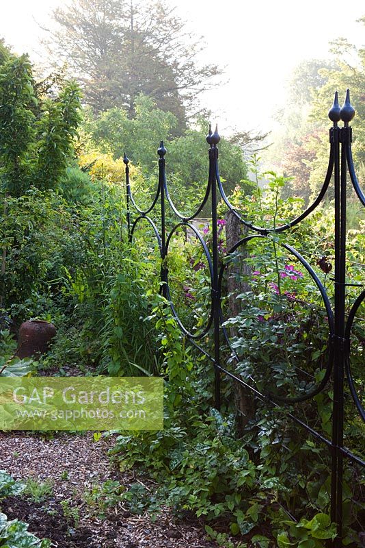 Walled kitchen garden in summer, agriframes screens in the garden - Cerney Gardens, Gloucestershire