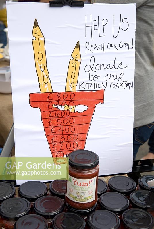 Sign supporting the sale of pasta sauce using tomatoes grown by children in the kitchen garden of a local school, with proceeds being used towards further development of their garden - Orford, Suffolk