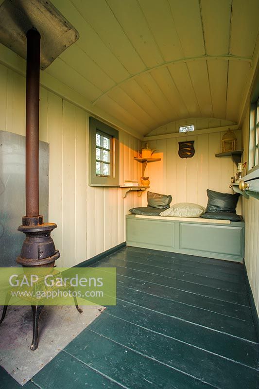 Interior of shepherds hut with pot belly stove - The Mill House, Little Sampford, Essex