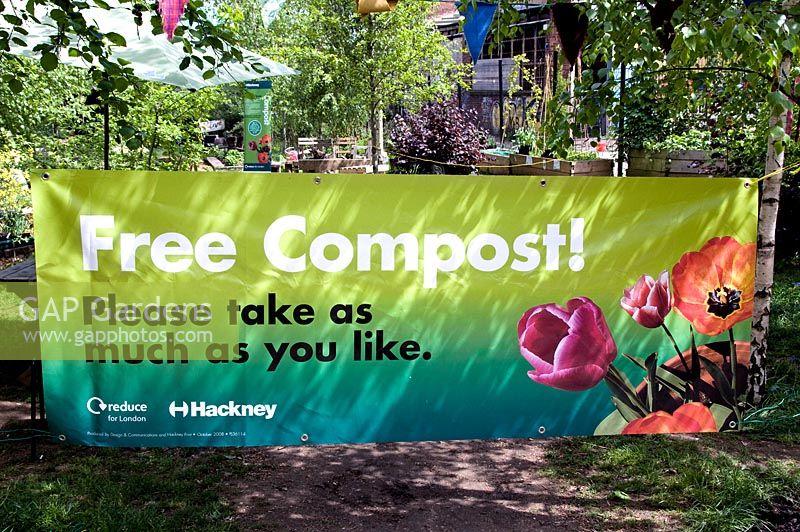 Banner sayiing Free Compost, Please take as much as you like. Compost supplied by Hackney Council and made from recycled waste, Dalston Eastern Curve Garden, London, UK