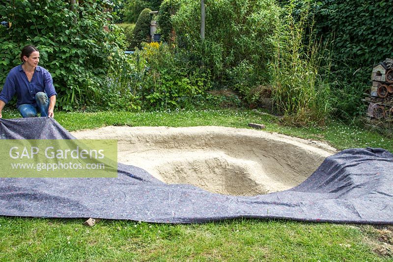 Adding liner to the excavated pond