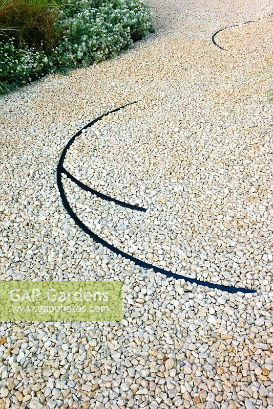 Gravel path in the 'Between the Lines' garden designed by Maurice Butcher at the RHS Hampton Court Flower Show. Sponsors -  Burlington Garden Design, Harvest Nurseries. 