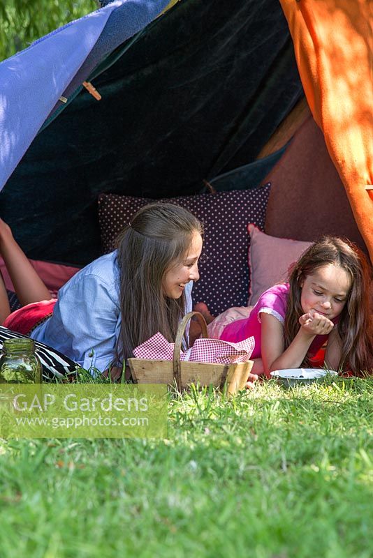 Children playing in garden den