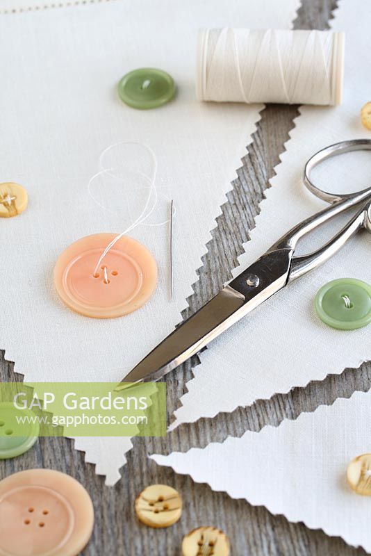 Step by step of making garden bunting with vintage linens and buttons - Make use of any plain areas of linen by sewing on old buttons