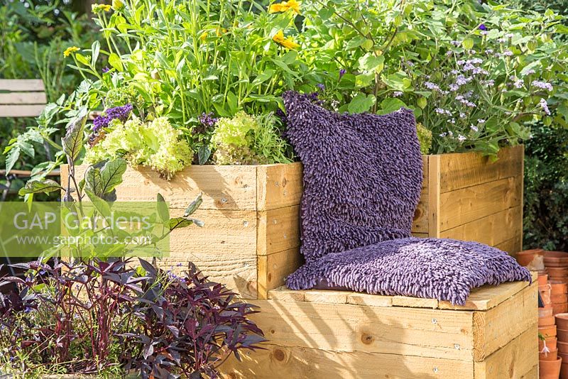 Moveable container with cushioned seat in small suburban garden