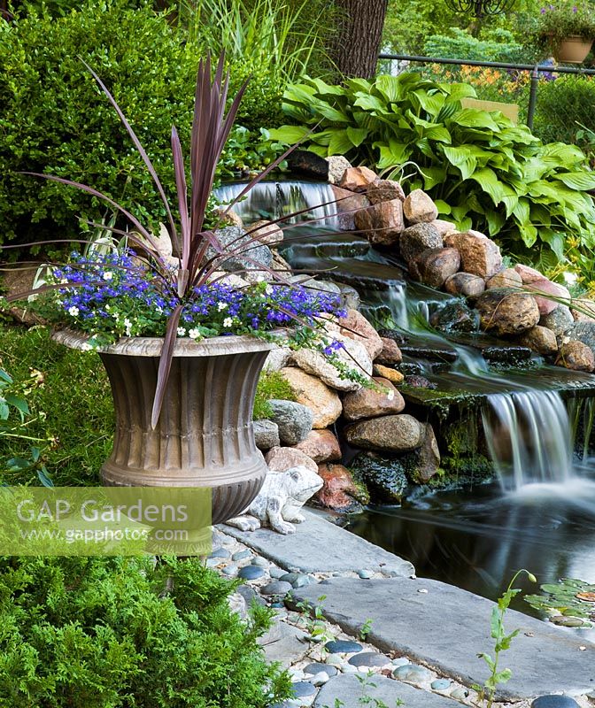Pond with waterfall and mixed planting 