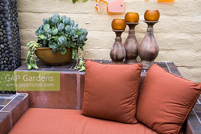 Outdoor living area, seating, candles and container with Kalanchoe marmorata, Sedum morganianum