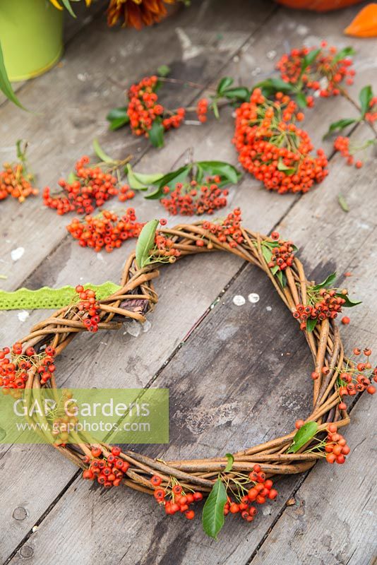 A woven heart wreath with Pyracantha berries