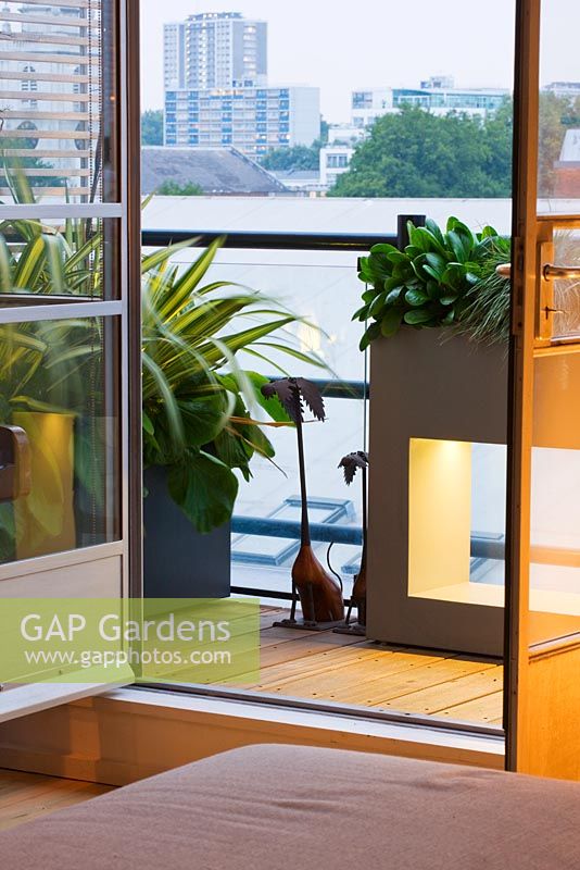 View out of an apartment to terrace with containers