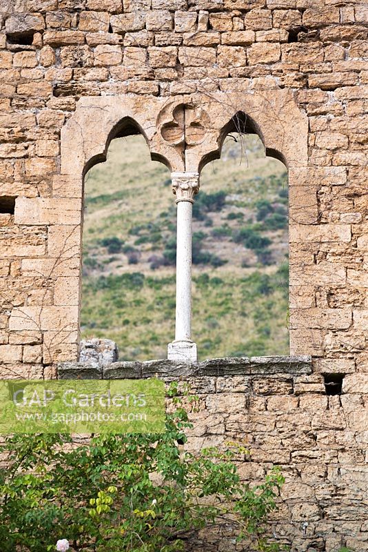 Ninfa garden, Giardini di Ninfa, Italy. Window though ruin wall