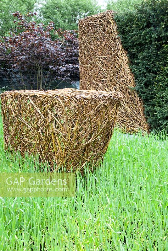 Willow sculpture by Emma Stothard in drift of barley. As Nature Intended Garden, Chelsea Flower Show 2013