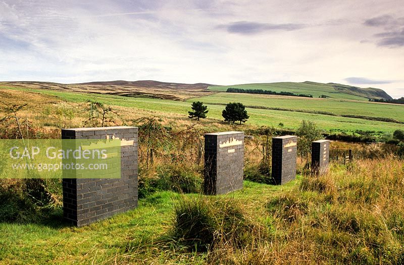 'Camouflaged Flowers'. View of the series of plinths. Little Sparta, Dunsyre, Lanark, Lanarkshire. Scotland.
