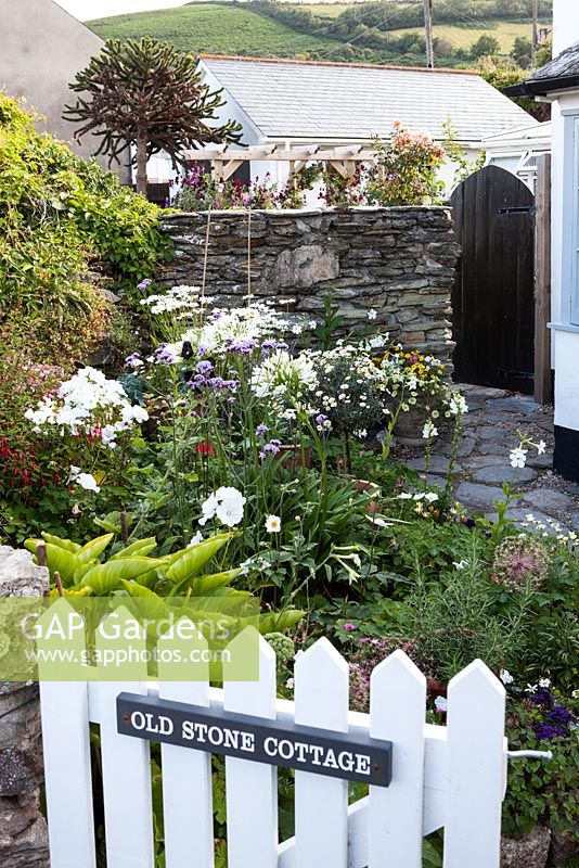 Front garden with painted white gate 