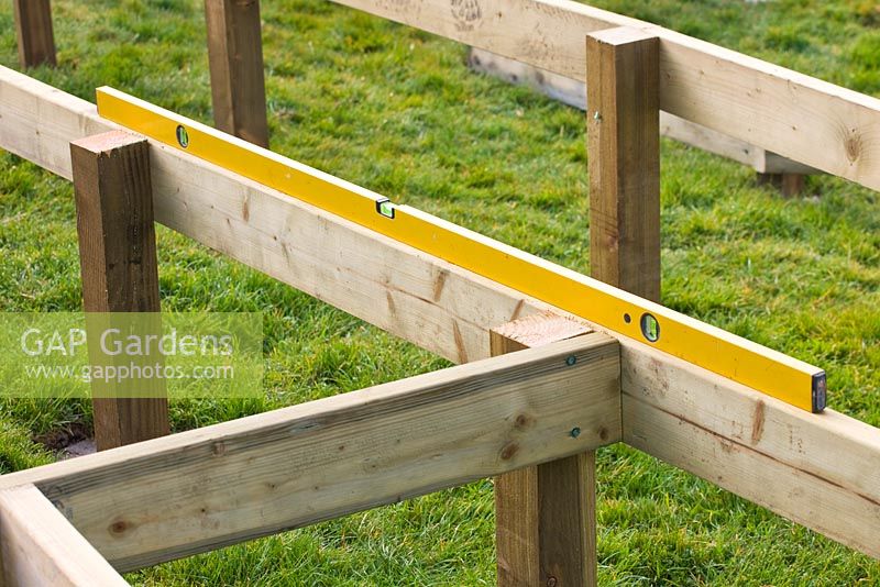 Constructing a circular deck - wooden joists for decking with spirit level