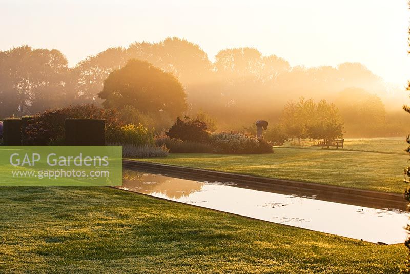 Mist rises off the canal at dawn. Waterperry Gardens, Oxfordshire