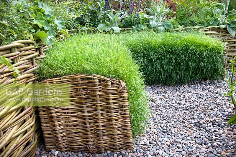 Wicker sided turf seat surrounded by raised bed and flowering perennial plants. Limerick Culture Garden. Large Garden Silver Medal Winner by Ailish Drake at Bloom Garden Festival Ireland 2014. 