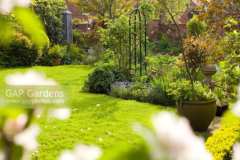 Looking across the lawn towards the obelisk. Hope House Garden, Caistor, Lincolnshire, UK. April 2014.