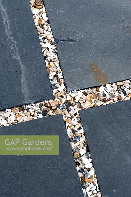 Contrasting textures of 20ml gravel Moonstone with slate natural stone paving in squares