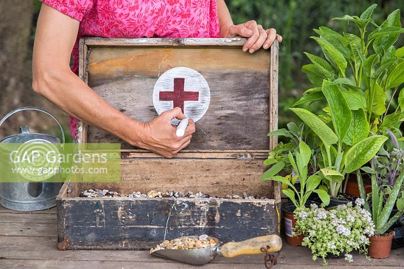 Drawing a medical cross on the case. 
