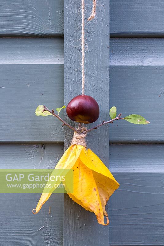 Conker Fairy. Materials used are Aesculus hippocastanum - Conkers, Jute twine, autumnal leaves and a Prunus cutting. 